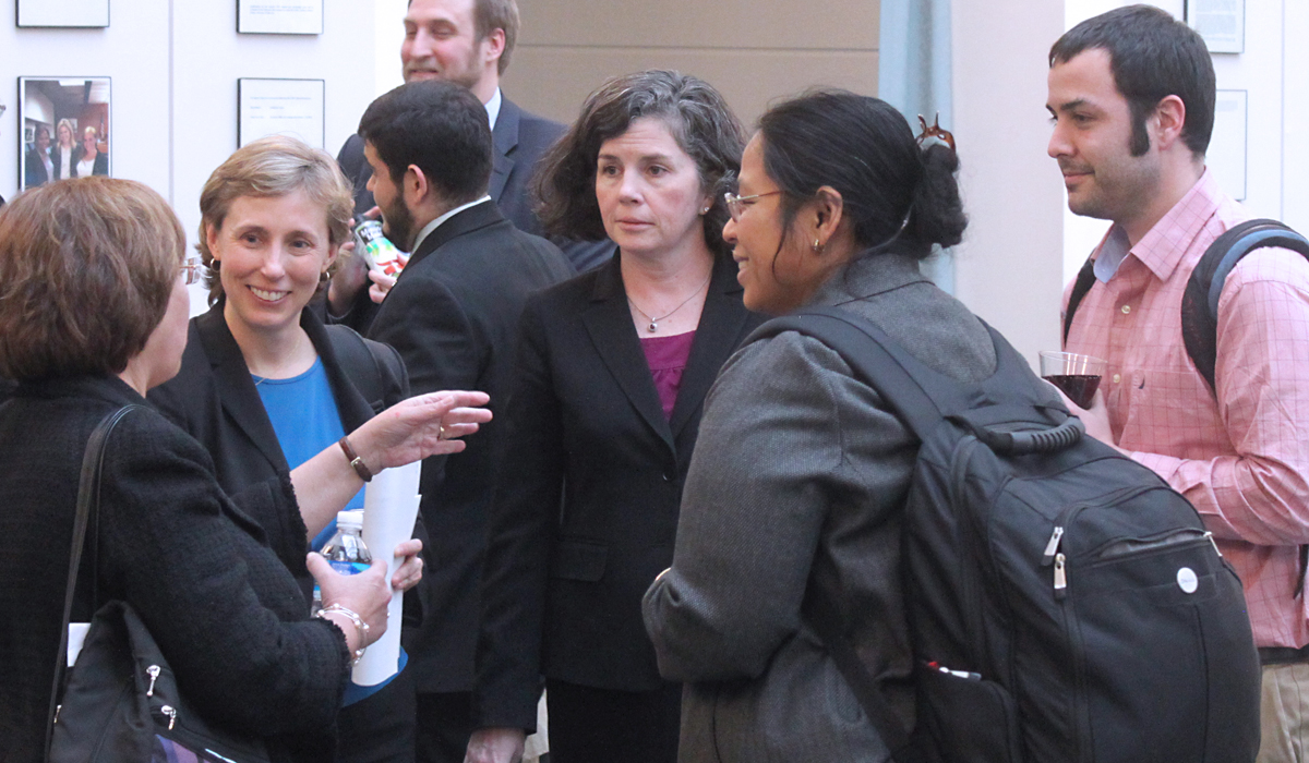 group of people talking in the law school atrium