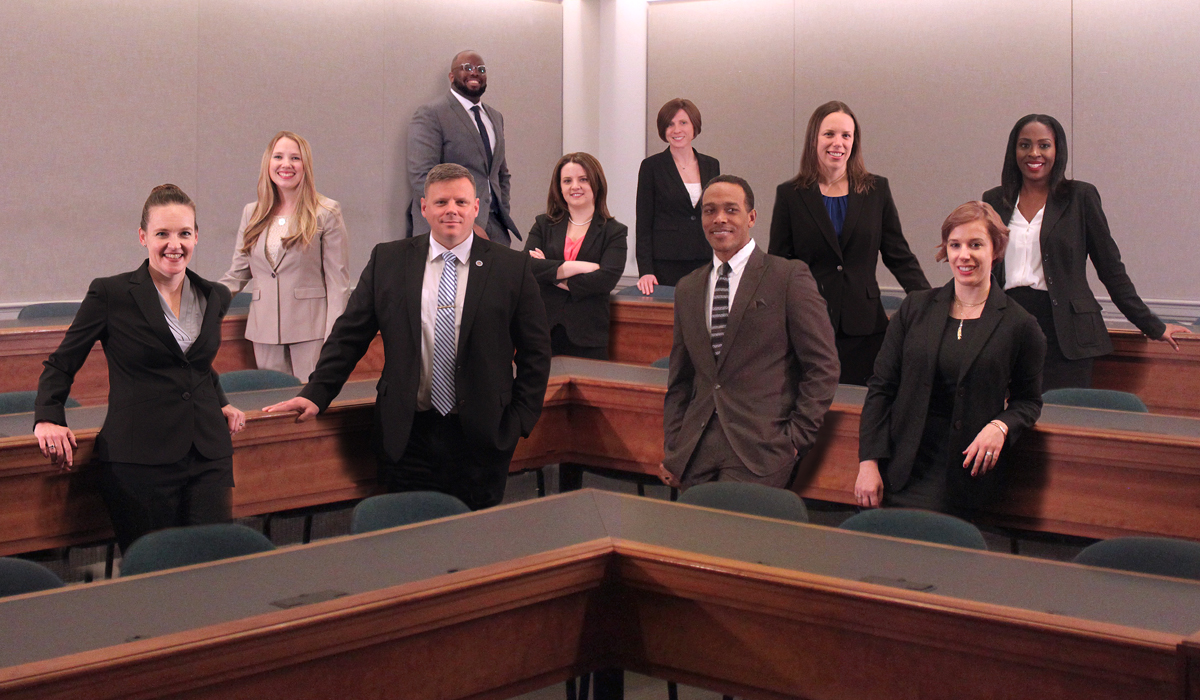 group of law students standing in a classroom