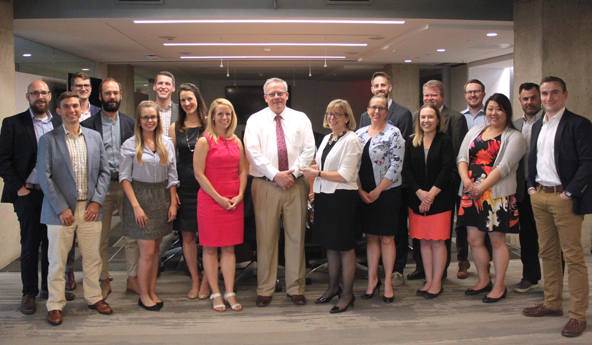 group of students and alumni posing for a photo at the LTIAA Pay It Forward event