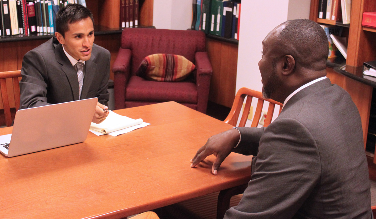 A law student works in the clinic with a client