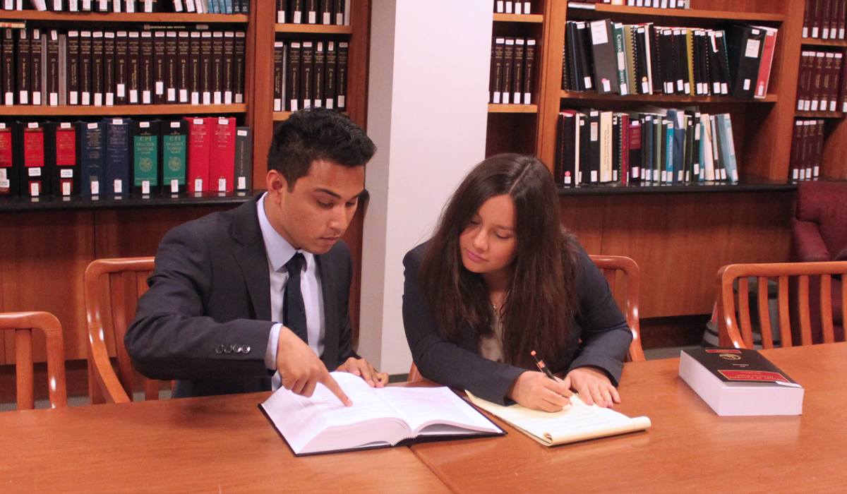 Two students researching in library