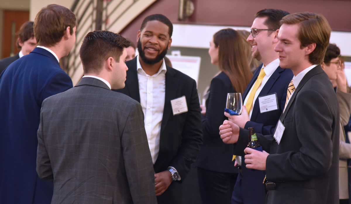 a group of clerks talking at the conference welcome reception