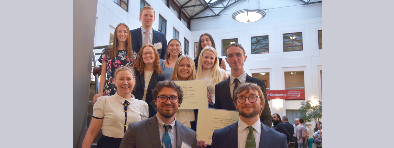 group of students posing for a photo in the law school atrium