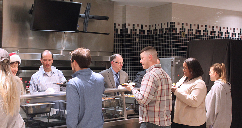 faculty and staff serve breakfast