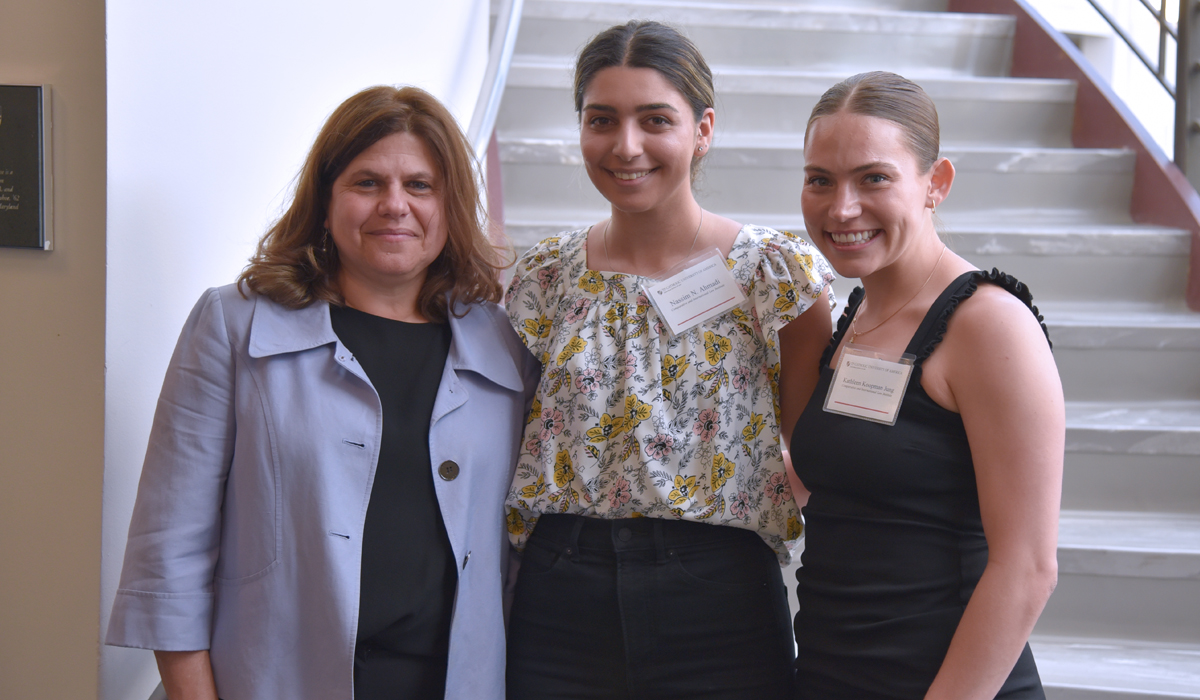 group of students posing for a photo in the law school atrium