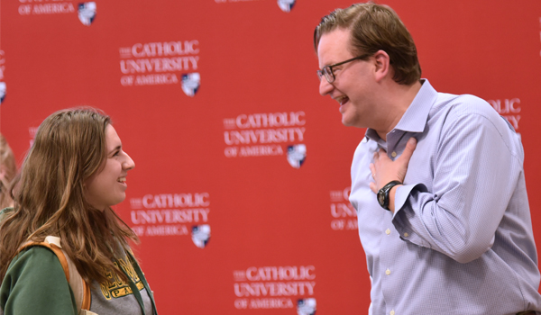 Stolarz talking to a CatholicU student