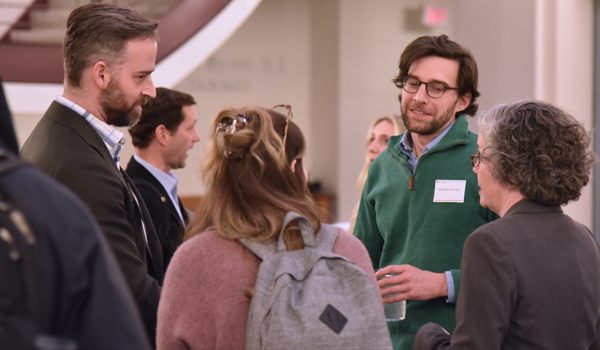 Students, alumni, and faculty talking