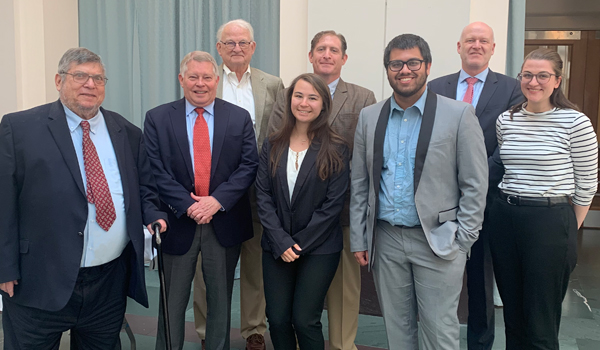 Group of students and faculty with J. Michael Luttig