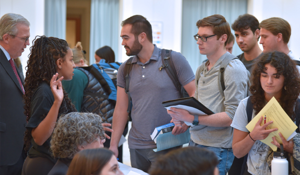 students talking to other students about securities law program