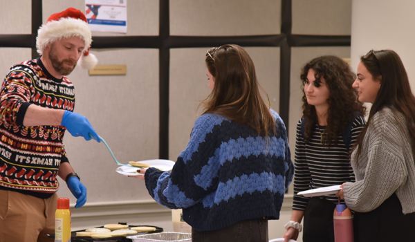 Bryan serving pancakes to law students