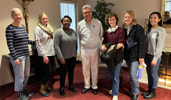 Students posing with the University president