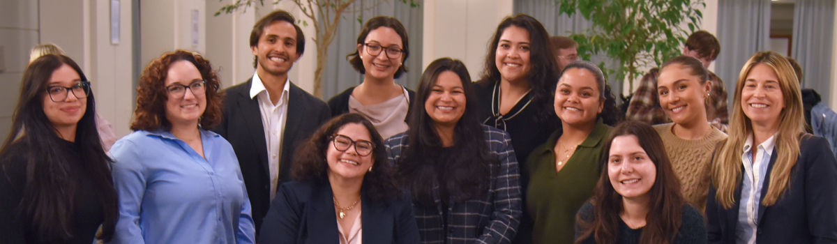 Law students and legal professionals pose for a photo