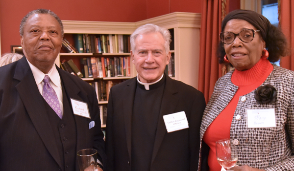 Father O'Brien with an alumnus and his wife.