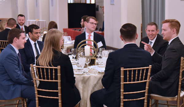 Clerks and judges talking at dinner
