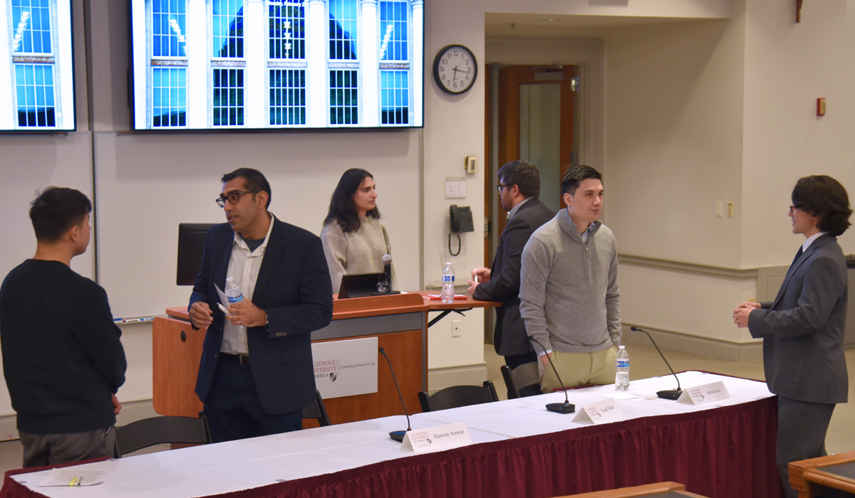 Panelists networking with Catholic Law students