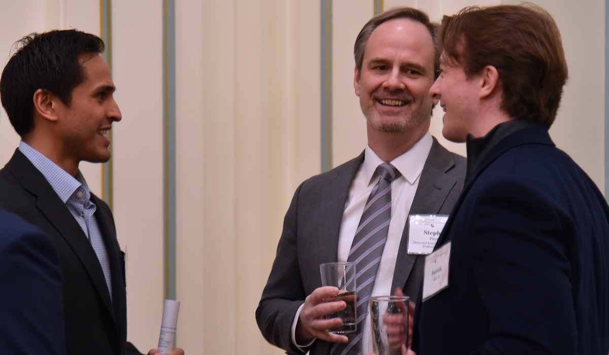 Steve Payne with two alumni