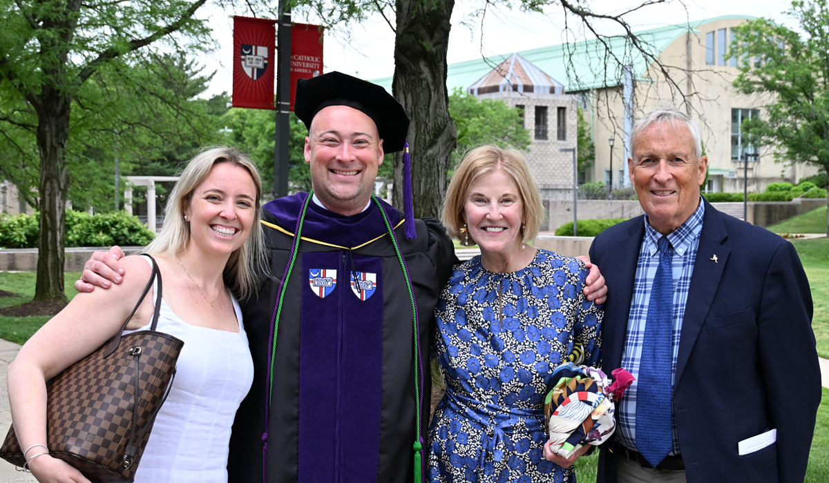 A graduate with his family