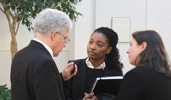 Professor Perez talks to students