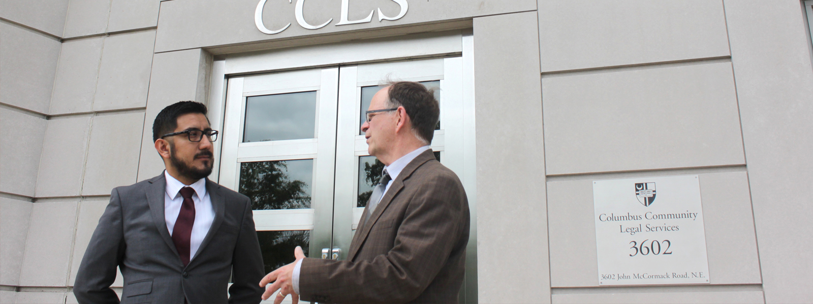 a student and faculty member standing in front of CCLS