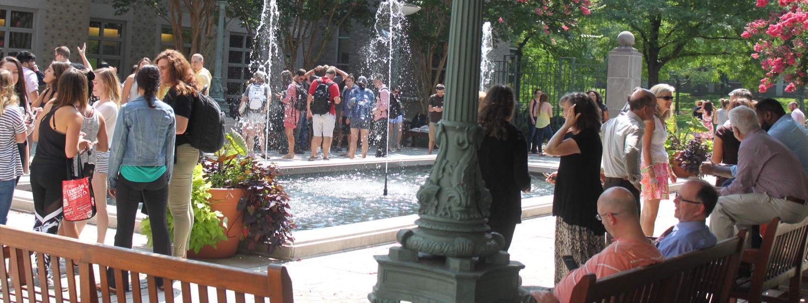 Group of law students and faculty outside of the law school by the fountain