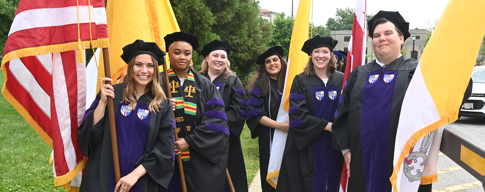 Members of the Class of 2022 holding flags at graduation