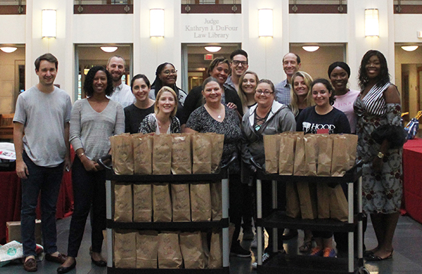 Group of CUA Law students and staff pose for a photo in the law school atrium