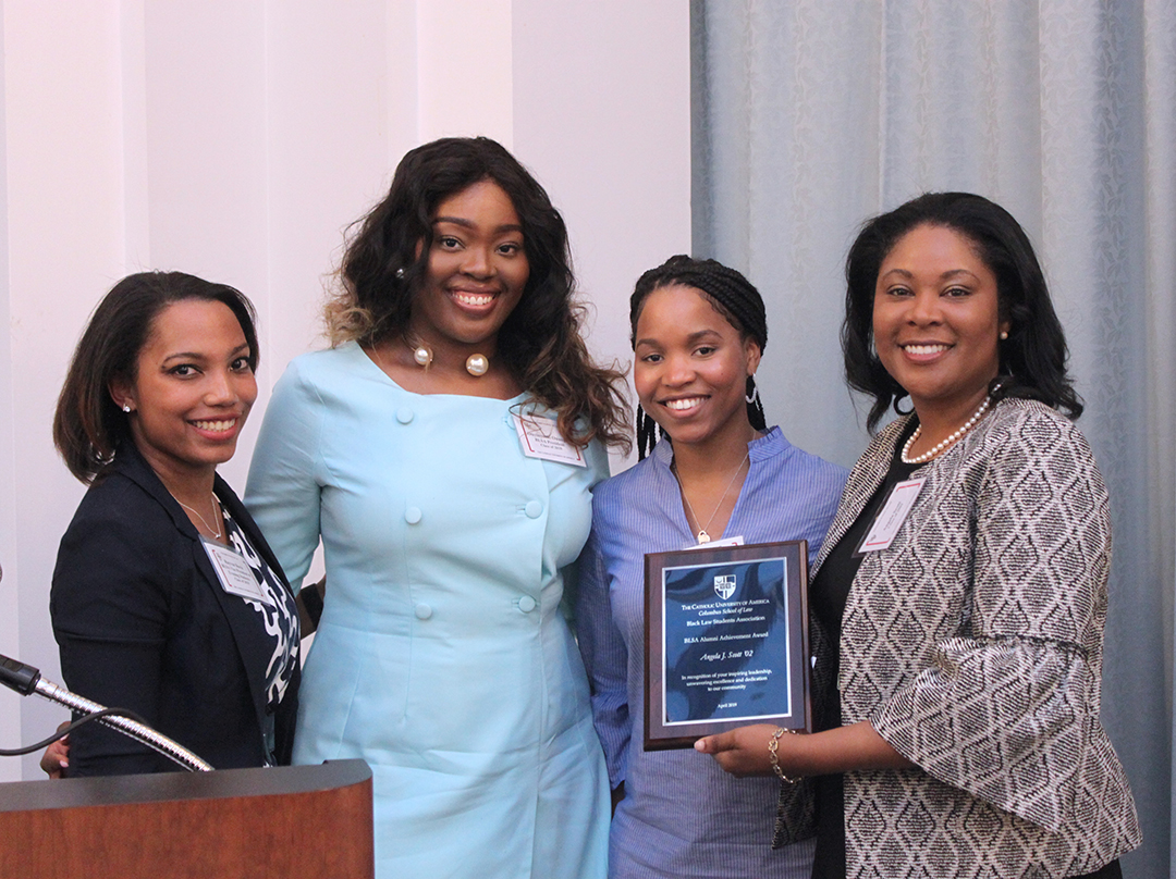 Angela Scott posing with BLSA apes and award