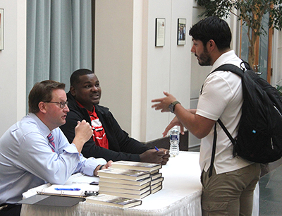 a student talking to Brian and Alfred