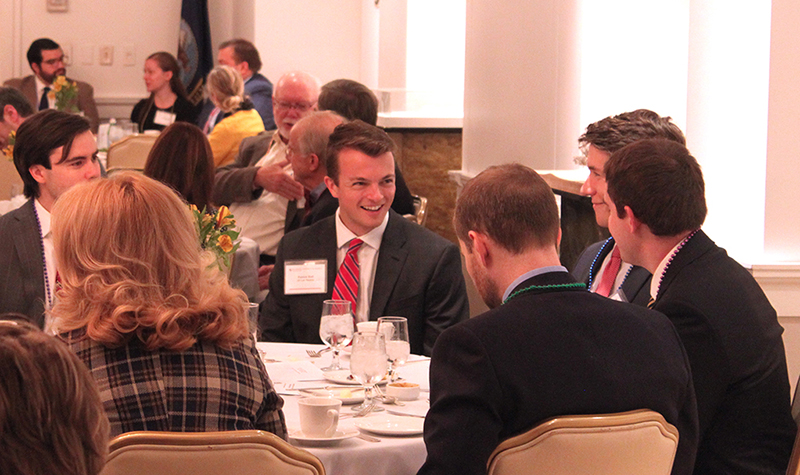 A group of people talking at a luncheon